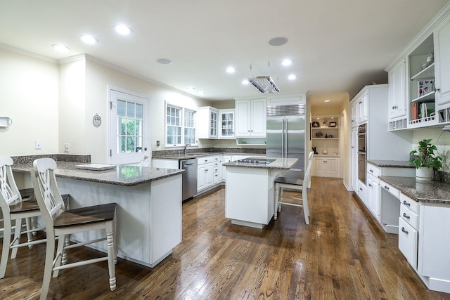 1925 Kentwood Ct, Darien, IL 60561 - kitchen with stainless steel appliances, crown molding, a peninsula, a kitchen bar, and white cabinetry