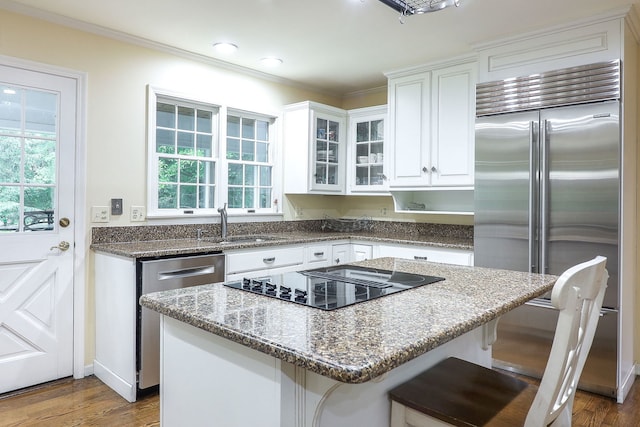 1925 Kentwood Ct, Darien, IL 60561 - kitchen with appliances with stainless steel finishes, dark stone countertops, white cabinets, plenty of natural light, and ornamental molding
