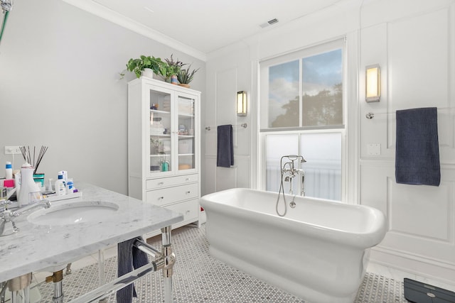 2429 W Belden Ave, Chicago, IL 60647 - bathroom featuring a freestanding tub, tile patterned flooring, crown molding, and vanity
