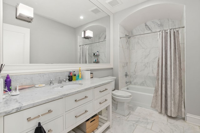 2429 W Belden Ave, Chicago, IL 60647 - bathroom with shower / tub combo, vanity, and marble look tiles