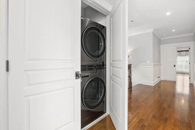 2429 W Belden Ave, Chicago, IL 60647 - laundry room with stacked washer / dryer, crown molding, dark wood-style flooring, wainscoting, and a decorative wall