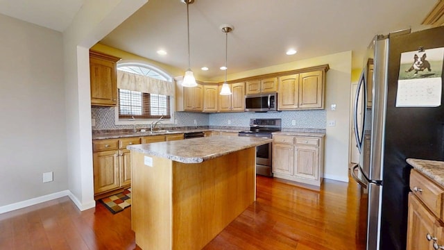 4005 Pebblebrook Ln, Champaign, IL 61822 - kitchen with stainless steel appliances, dark wood finished floors, backsplash, a center island, and light countertops