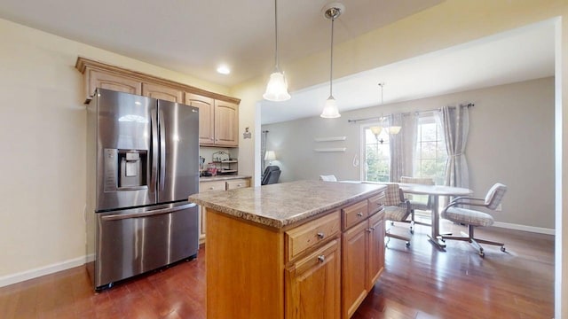 4005 Pebblebrook Ln, Champaign, IL 61822 - kitchen with stainless steel refrigerator with ice dispenser, dark wood-style floors, a center island, light countertops, and decorative light fixtures