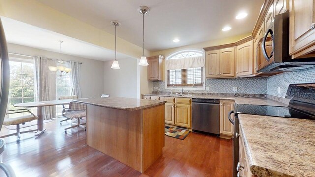 4005 Pebblebrook Ln, Champaign, IL 61822 - kitchen featuring appliances with stainless steel finishes, dark wood finished floors, light brown cabinetry, a center island, and plenty of natural light