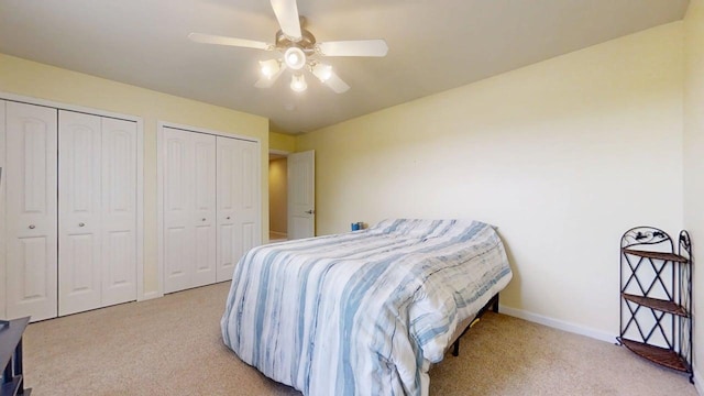 4005 Pebblebrook Ln, Champaign, IL 61822 - bedroom with carpet floors, two closets, and a ceiling fan