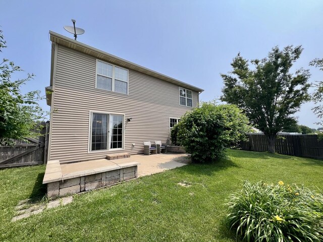 4005 Pebblebrook Ln, Champaign, IL 61822 - rear view of house with a patio area and a fenced backyard