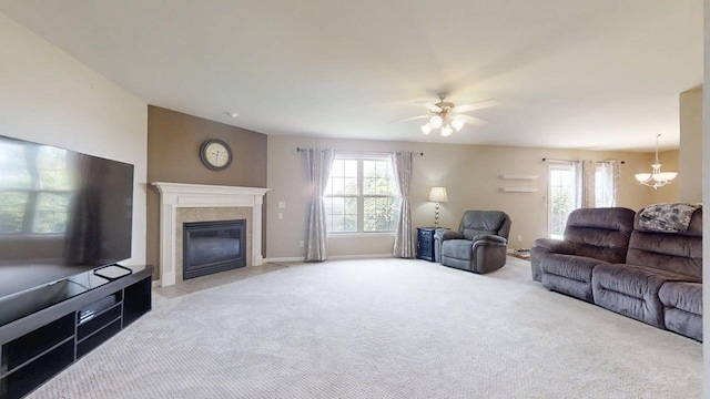 4005 Pebblebrook Ln, Champaign, IL 61822 - carpeted living area with a chandelier, a tile fireplace, and a ceiling fan