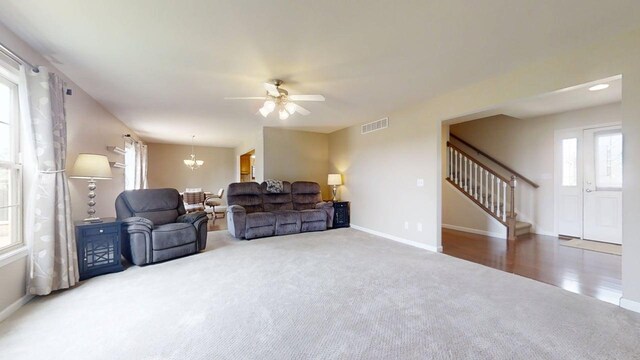 4005 Pebblebrook Ln, Champaign, IL 61822 - living area with carpet, stairs, ceiling fan, and a chandelier
