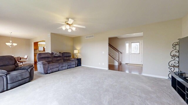 4005 Pebblebrook Ln, Champaign, IL 61822 - living area featuring carpet, ceiling fan, stairs, and a chandelier