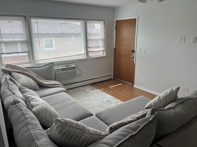 7020 W Diversey Ave Unit 3, Chicago, IL 60707 - living area with a baseboard radiator, wood finished floors, a wall unit AC, and baseboards