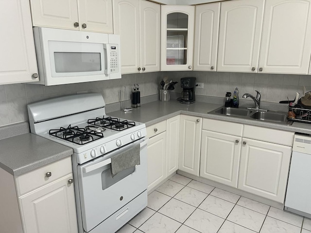 7020 W Diversey Ave Unit 3, Chicago, IL 60707 - kitchen with white appliances, a sink, white cabinetry, light marble finish flooring, and decorative backsplash