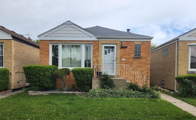7112 W Farragut Ave, Chicago, IL 60656 - view of front of property with a front yard, brick siding, and a shingled roof