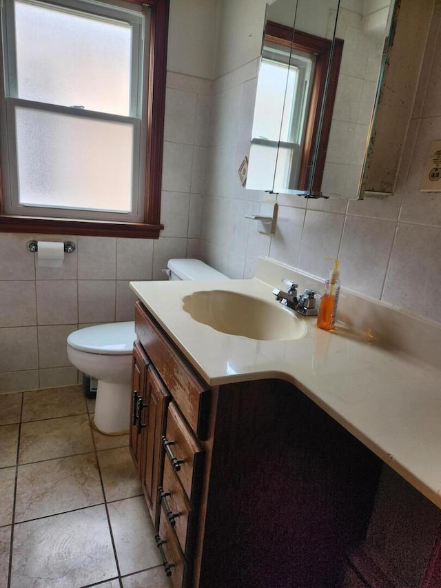 7112 W Farragut Ave, Chicago, IL 60656 - bathroom featuring tile walls, vanity, toilet, and tile patterned floors