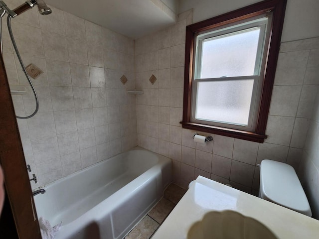 7112 W Farragut Ave, Chicago, IL 60656 - bathroom featuring tile walls, toilet, tile patterned flooring, and bathtub / shower combination
