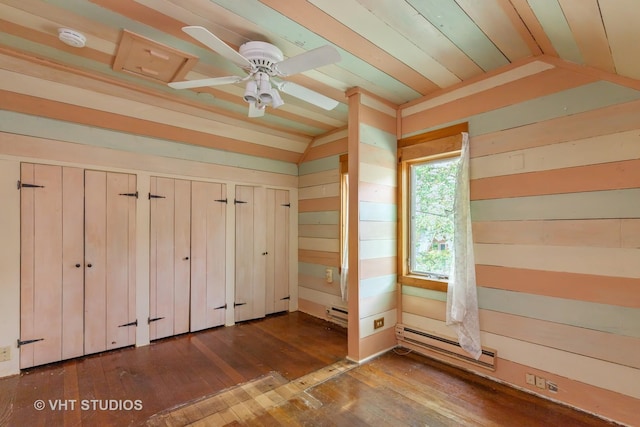 34140 N Hickory Ave, Grayslake, IL 60030 - unfurnished bedroom with a baseboard radiator, vaulted ceiling, hardwood / wood-style flooring, two closets, and wood walls