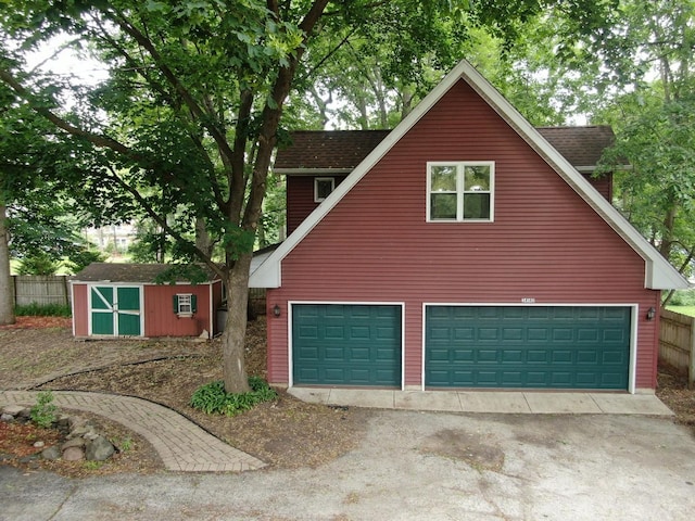 34140 N Hickory Ave, Grayslake, IL 60030 - view of front of house featuring a storage unit, a garage, and driveway