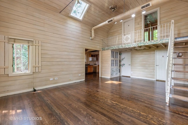 34140 N Hickory Ave, Grayslake, IL 60030 - unfurnished living room featuring a skylight, high vaulted ceiling, wooden walls, and wood-type flooring
