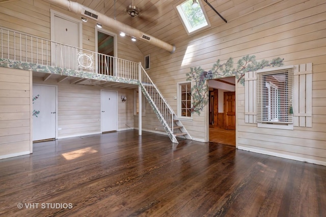 34140 N Hickory Ave, Grayslake, IL 60030 - unfurnished living room featuring wood walls, a skylight, stairs, high vaulted ceiling, and wood finished floors