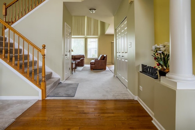 400 Bower Ln, Oswego, IL 60543 - carpeted foyer featuring stairs, wood finished floors, ornate columns, and baseboards