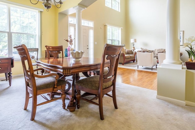 400 Bower Ln, Oswego, IL 60543 - dining area featuring decorative columns, light colored carpet, and a chandelier