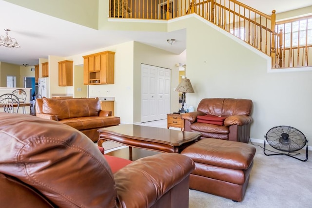 400 Bower Ln, Oswego, IL 60543 - living room featuring a high ceiling, carpet, baseboards, and a chandelier