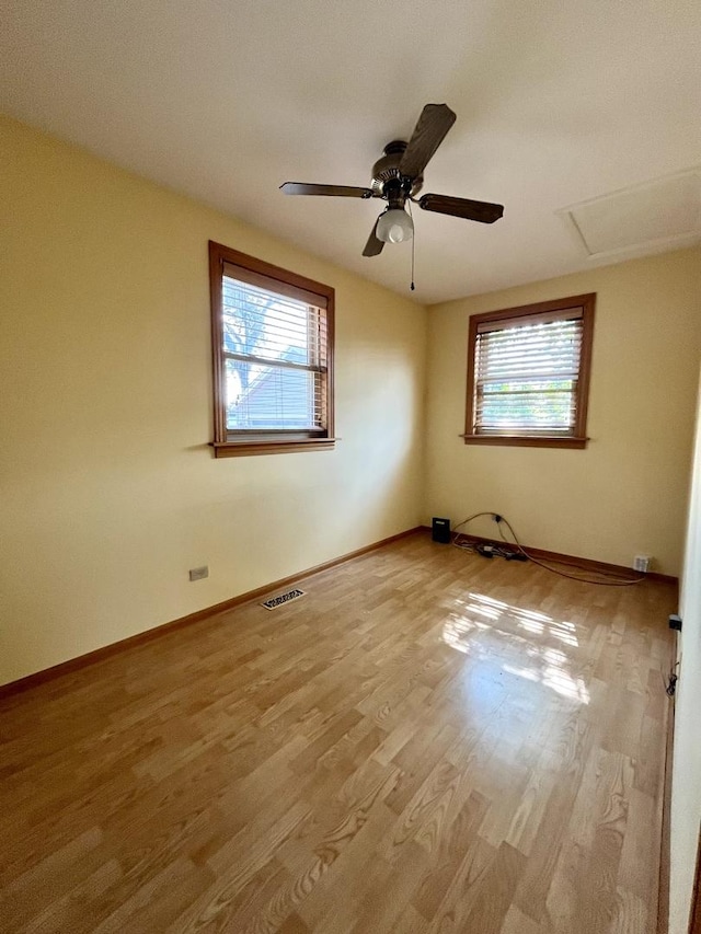 1140 Blanchan Ave, La Grange Park, IL 60526 - empty room with healthy amount of natural light, wood finished floors, a ceiling fan, and baseboards