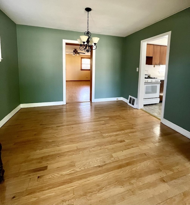 1140 Blanchan Ave, La Grange Park, IL 60526 - unfurnished dining area featuring a chandelier, wood finished floors, and baseboards