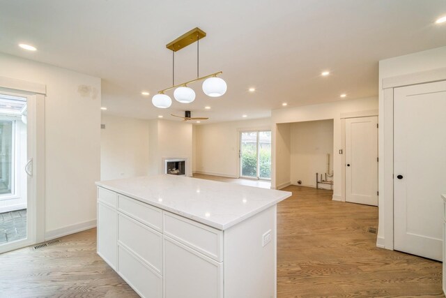2240 Vista Ct, Northbrook, IL 60062 - kitchen featuring a kitchen island, light wood-type flooring, pendant lighting, white cabinets, and recessed lighting