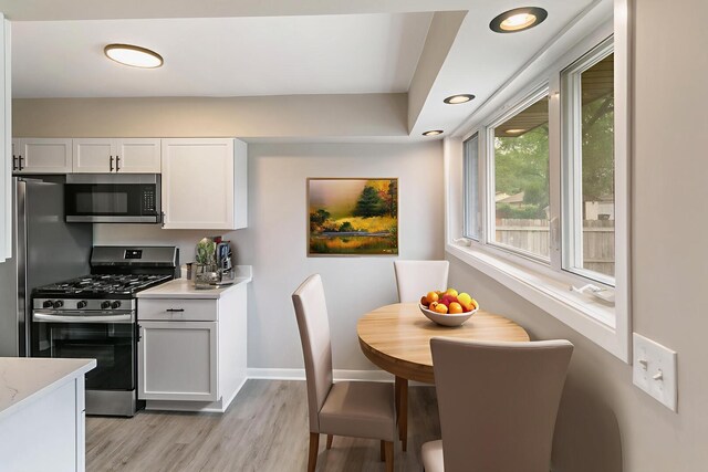 17303 Chicago Ave, Lansing, IL 60438 - kitchen featuring stainless steel appliances, light wood-style flooring, baseboards, white cabinetry, and recessed lighting