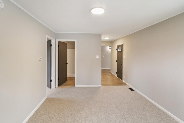 17303 Chicago Ave, Lansing, IL 60438 - unfurnished room featuring light colored carpet, baseboards, crown molding, and a smoke detector