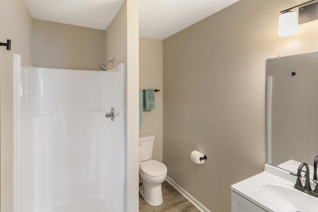 17303 Chicago Ave, Lansing, IL 60438 - full bath with toilet, a shower, vanity, wood finished floors, and baseboards