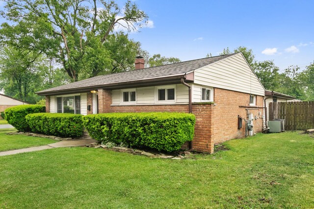 17303 Chicago Ave, Lansing, IL 60438 - ranch-style house with a chimney, brick siding, and central air condition unit
