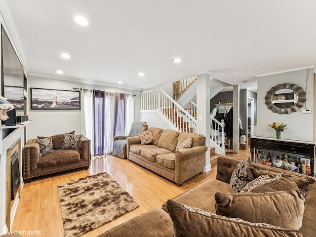 665 Cindy Ln, Wheeling, IL 60090 - living room with stairs, crown molding, recessed lighting, wood finished floors, and a fireplace