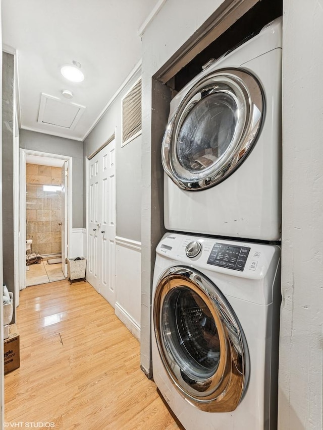 665 Cindy Ln, Wheeling, IL 60090 - laundry room featuring stacked washer / drying machine, light wood finished floors, and attic access