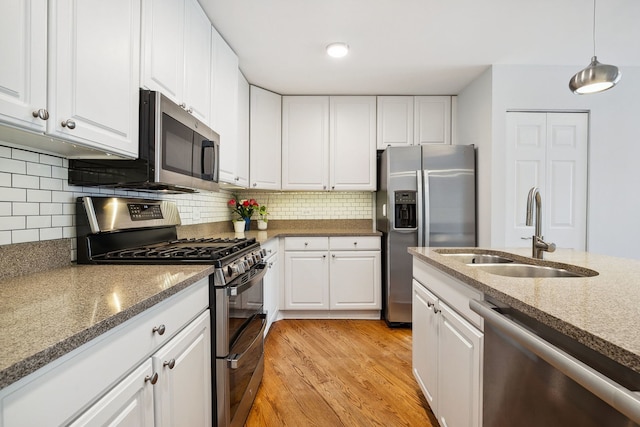 2417 N Janssen Ave Unit C, Chicago, IL 60614 - kitchen featuring appliances with stainless steel finishes, a sink, light wood-style flooring, and white cabinets