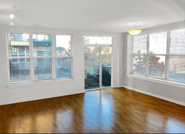 2231 W Maypole Ave Unit 201, Chicago, IL 60612 - unfurnished room with wood finished floors and baseboards