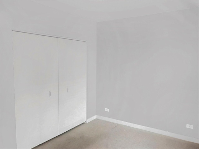 2231 W Maypole Ave Unit 201, Chicago, IL 60612 - unfurnished bedroom featuring a closet and light colored carpet