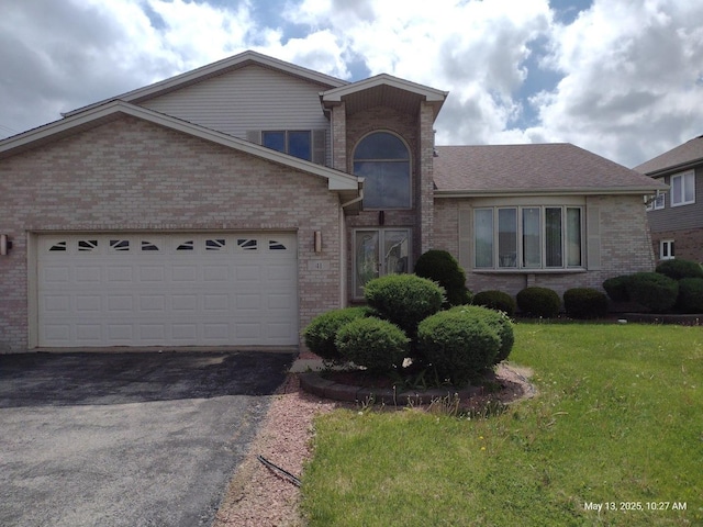 41 Manor Dr, Matteson, IL 60443 - view of front of property featuring driveway, brick siding, a front lawn, and a garage