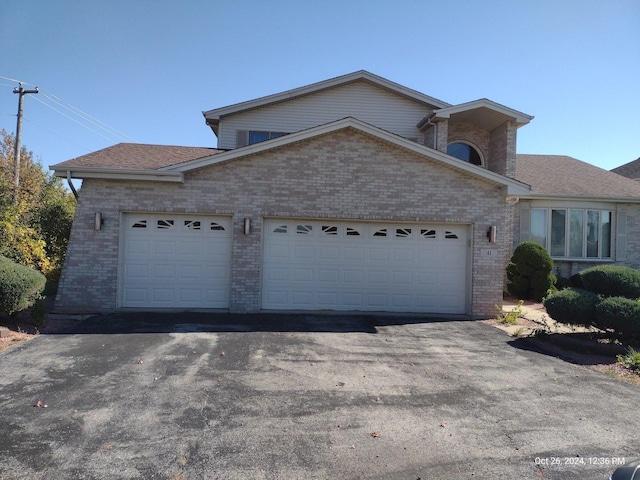 41 Manor Dr, Matteson, IL 60443 - view of front of house with brick siding, a garage, and asphalt driveway