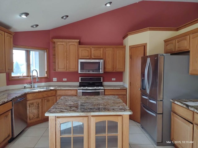41 Manor Dr, Matteson, IL 60443 - kitchen featuring stainless steel appliances, a sink, lofted ceiling, light stone counters, and light tile patterned floors