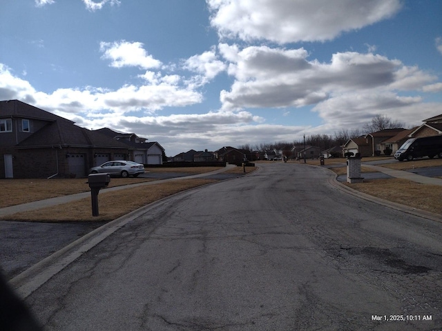 41 Manor Dr, Matteson, IL 60443 - view of asphalt road featuring a residential view, curbs, and sidewalks