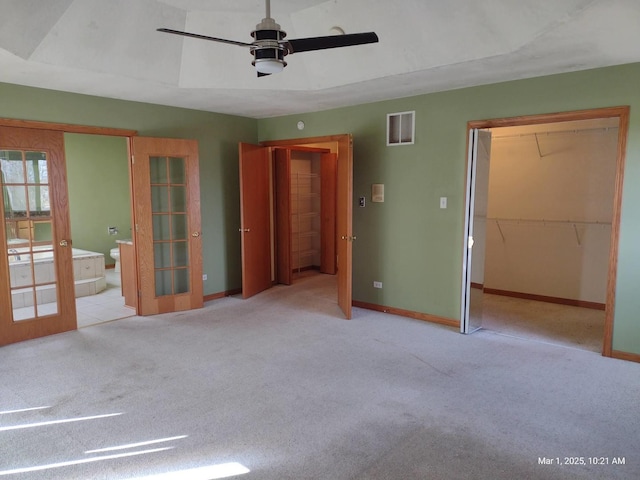 41 Manor Dr, Matteson, IL 60443 - unfurnished bedroom with french doors, carpet flooring, baseboards, a walk in closet, and a ceiling fan