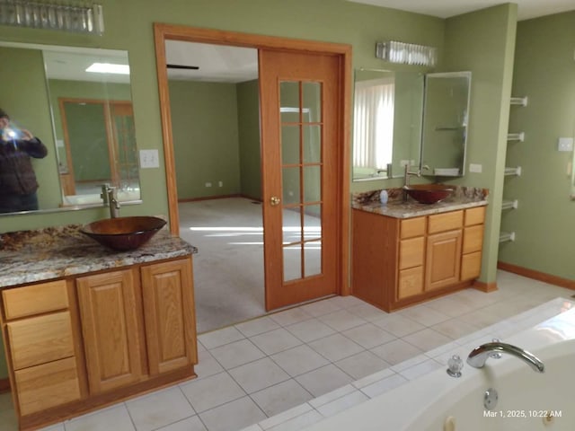 41 Manor Dr, Matteson, IL 60443 - full bathroom featuring two vanities, a bath, french doors, and tile patterned flooring