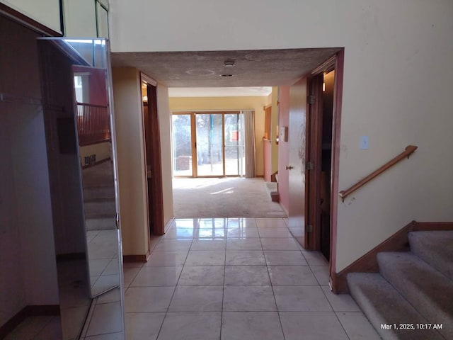 41 Manor Dr, Matteson, IL 60443 - hallway with light tile patterned floors, stairs, light colored carpet, and baseboards