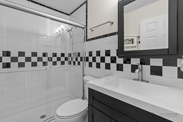 634 Primrose Ln, Schaumburg, IL 60194 - full bath featuring toilet, vanity, a shower stall, tile walls, and tasteful backsplash