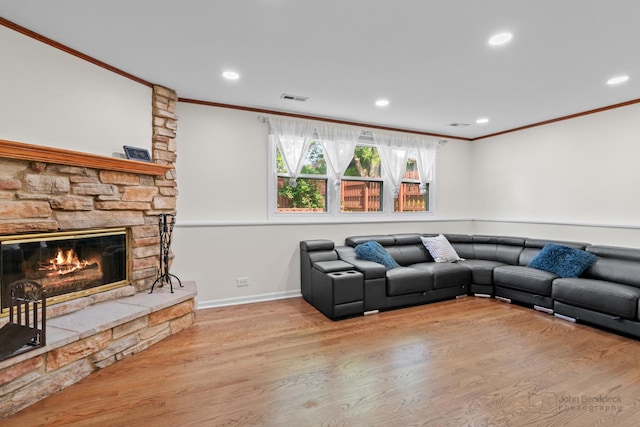 634 Primrose Ln, Schaumburg, IL 60194 - living room featuring crown molding, wood finished floors, a stone fireplace, recessed lighting, and baseboards