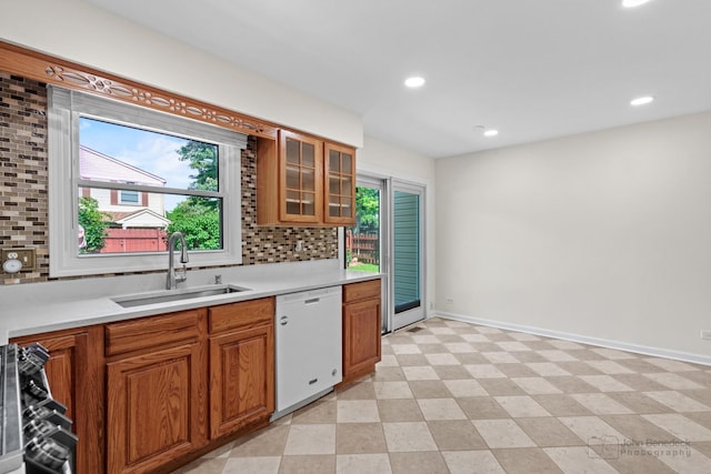 634 Primrose Ln, Schaumburg, IL 60194 - kitchen with dishwasher, a sink, light countertops, brown cabinets, and recessed lighting
