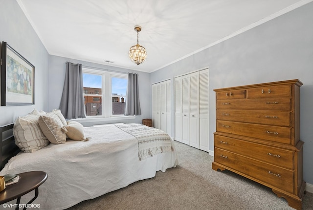 307 W Harris Ave Unit 3A, La Grange, IL 60525 - carpeted bedroom featuring two closets, crown molding, and a chandelier