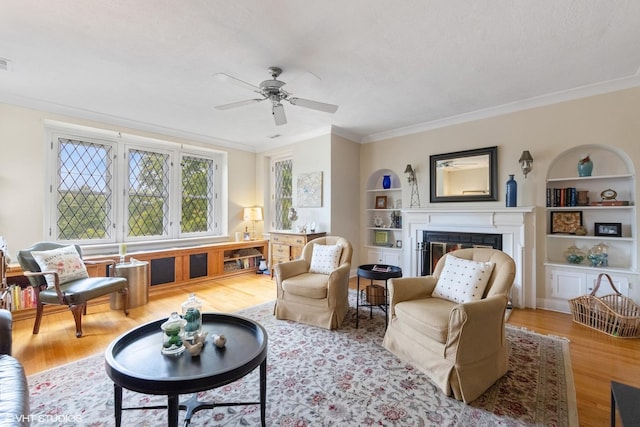 307 W Harris Ave Unit 3A, La Grange, IL 60525 - living area featuring crown molding, wood finished floors, built in shelves, ceiling fan, and a glass covered fireplace