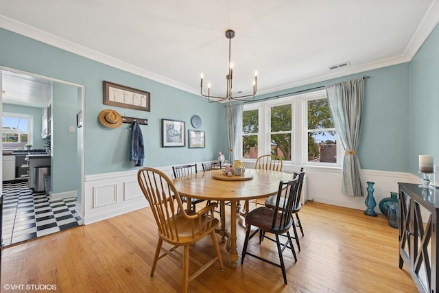307 W Harris Ave Unit 3A, La Grange, IL 60525 - dining area with a chandelier, light wood-style flooring, ornamental molding, and wainscoting